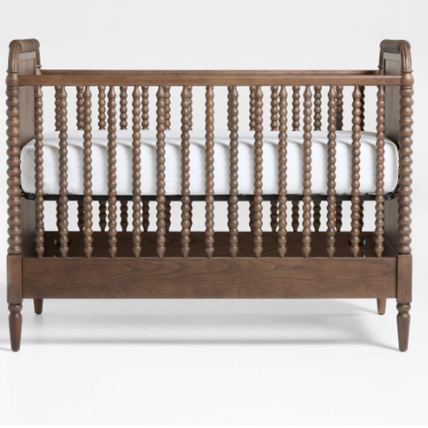 Wooden crib with spindles on a white background