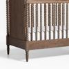 Wooden crib with spindles on a white background