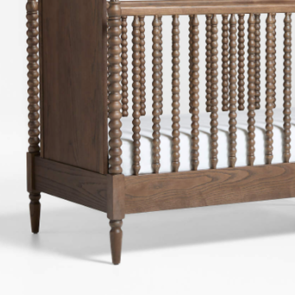 Wooden crib with spindles on a white background