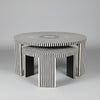 Set of three black and white patterned tables on a gray background