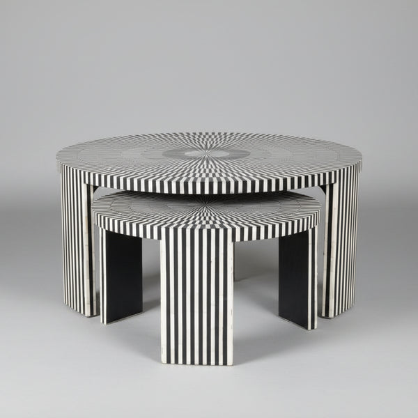 Set of three black and white patterned tables on a gray background