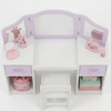 Children's vanity table with mirrors and various accessories on a white background