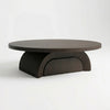 A modern round coffee table with a dark wood top and a sculptural, ribbed semi-circular pedestal base, shown on a clean white studio background.